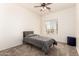 Bedroom with neutral carpet, ceiling fan, window for natural light and gray bed at 10539 W Tamara Dr, Casa Grande, AZ 85193