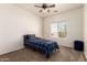Well-lit bedroom featuring neutral paint, a ceiling fan, and carpeted flooring at 10539 W Tamara Dr, Casa Grande, AZ 85193