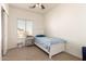 Bedroom features a blue bed with a white frame, neutral carpet and a ceiling fan at 10539 W Tamara Dr, Casa Grande, AZ 85193