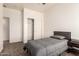Carpeted bedroom with closet, ceiling fan and bed frame with gray bedding at 10539 W Tamara Dr, Casa Grande, AZ 85193