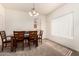 Formal dining room with a wooden table set on neutral carpet at 10539 W Tamara Dr, Casa Grande, AZ 85193