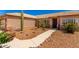 Desert home with beige exterior, concrete walkway, and xeriscaped front yard at 10539 W Tamara Dr, Casa Grande, AZ 85193