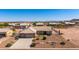 Aerial view of home with desert landscaping, mature trees, and three car garage at 10539 W Tamara Dr, Casa Grande, AZ 85193