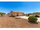 Spacious three-car garage, xeriscaping, beige exterior, and convenient circular fire pit area at 10539 W Tamara Dr, Casa Grande, AZ 85193