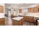 Bright kitchen features wooden cabinetry, modern appliances, and view to a dining area at 10539 W Tamara Dr, Casa Grande, AZ 85193