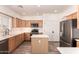 Charming kitchen offers stainless appliances, wood cabinets and a center island at 10539 W Tamara Dr, Casa Grande, AZ 85193