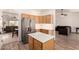 Modern kitchen features a stainless steel refrigerator, island, and stylish light-wood cabinets at 10539 W Tamara Dr, Casa Grande, AZ 85193