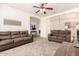 Comfortable living room with plush seating, ceiling fan, and an open layout, perfect for relaxing at 10539 W Tamara Dr, Casa Grande, AZ 85193