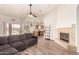 Open living room features modern flooring, a fireplace, and seamless flow to kitchen and outdoors at 10539 W Tamara Dr, Casa Grande, AZ 85193