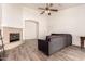 Bright living room features a cozy fireplace, modern flooring, and a ceiling fan at 10539 W Tamara Dr, Casa Grande, AZ 85193