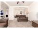 Inviting living room featuring neutral walls, plush carpet, and comfortable brown sofas at 10539 W Tamara Dr, Casa Grande, AZ 85193