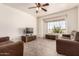 Living room with ample seating, ceiling fan, and view of natural light, creating a relaxing atmosphere at 10539 W Tamara Dr, Casa Grande, AZ 85193
