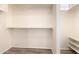 Walk-in closet with custom shelving and wood-look floors offers ample storage space at 10539 W Tamara Dr, Casa Grande, AZ 85193