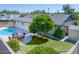 Aerial view of a backyard with pool, patio, turf, and mature landscaping at 1059 E Broadmor Dr, Tempe, AZ 85282