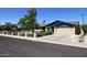 Street view of the home showing the front yard, fence, and attached garage at 1059 E Broadmor Dr, Tempe, AZ 85282