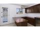 Home bar features dark wood cabinetry, bar top, door to outdoor pool area, and a window at 1059 E Broadmor Dr, Tempe, AZ 85282