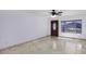Well-lit living room with tile floors, a window and a dark wood door at 1059 E Broadmor Dr, Tempe, AZ 85282