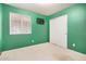 The vacant green bedroom provides closet space, natural light, and neutral carpeting at 1060 W Dava Dr, Tempe, AZ 85283