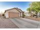 Single-story tan home with wide driveway and desert landscaping at 1060 W Dava Dr, Tempe, AZ 85283