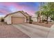 Single-story home with a two-car garage, desert landscaping, and a long driveway at 1060 W Dava Dr, Tempe, AZ 85283