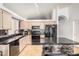 Bright eat-in kitchen featuring black appliances, and mosaic tile accent wall at breakfast bar at 1060 W Dava Dr, Tempe, AZ 85283