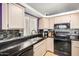 Modern kitchen featuring sleek appliances, black countertops and eye-catching mosaic tile backsplash at 1060 W Dava Dr, Tempe, AZ 85283