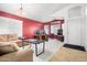 Living room with neutral carpet, red walls, and a large sofa at 1060 W Dava Dr, Tempe, AZ 85283
