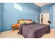 Blue-painted main bedroom features a large window, neutral carpet, and an en-suite bathroom at 1060 W Dava Dr, Tempe, AZ 85283