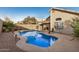 Backyard swimming pool with a rock landscaped perimeter and a concrete patio at 1060 W Dava Dr, Tempe, AZ 85283