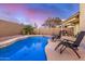 Backyard pool with lounge chairs, mature trees, and a privacy wall at 1060 W Dava Dr, Tempe, AZ 85283