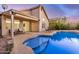 Backyard pool and patio area featuring chairs, a covered patio, and a landscaped yard at 1060 W Dava Dr, Tempe, AZ 85283
