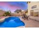 Backyard pool with lounge chairs, mature trees, and a privacy wall at 1060 W Dava Dr, Tempe, AZ 85283