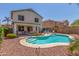 Backyard with a refreshing pool, covered patio, and desert landscaping for outdoor enjoyment at 1142 E Mayfield Dr, San Tan Valley, AZ 85143