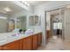 This bathroom features double sinks, a shower, a soaking tub, and a walk-in closet at 1142 E Mayfield Dr, San Tan Valley, AZ 85143