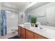Bathroom featuring double sinks, a soaking tub, and a shower with stylish tile surround at 1142 E Mayfield Dr, San Tan Valley, AZ 85143