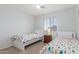 This bedroom features two twin beds and a large window for natural light at 1142 E Mayfield Dr, San Tan Valley, AZ 85143