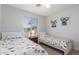 This bedroom features two twin beds and a large window for natural light at 1142 E Mayfield Dr, San Tan Valley, AZ 85143