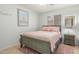 This bedroom features tile floors, a queen bed, and a large window for natural light at 1142 E Mayfield Dr, San Tan Valley, AZ 85143