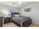 This bedroom features carpet, a queen bed, and a large window for natural light at 1142 E Mayfield Dr, San Tan Valley, AZ 85143
