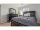 This bedroom features carpet, a queen bed, and a large window for natural light at 1142 E Mayfield Dr, San Tan Valley, AZ 85143