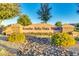 Entrance to Rancho Bella Vista South featuring lush landscaping and a stone monument sign at 1142 E Mayfield Dr, San Tan Valley, AZ 85143