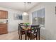 Cozy dining area featuring a wooden table, natural light, and an adjacent kitchen, perfect for Gathering meals at 1142 E Mayfield Dr, San Tan Valley, AZ 85143