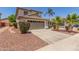 Two-story home with desert landscaping, a tile roof, and an attached two-car garage, blending style with functionality at 1142 E Mayfield Dr, San Tan Valley, AZ 85143