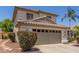 Charming two-story home featuring a tile roof, manicured landscaping, and a spacious two-car garage at 1142 E Mayfield Dr, San Tan Valley, AZ 85143