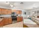 Modern kitchen with stainless steel appliances, wooden cabinets, and natural light creating an inviting cooking space at 1142 E Mayfield Dr, San Tan Valley, AZ 85143