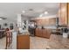 Well-equipped kitchen with stainless steel appliances, wooden cabinetry, and open view to the living area at 1142 E Mayfield Dr, San Tan Valley, AZ 85143