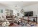 Comfortable living room with plush sectional sofa, decorative rug, and modern decor accents throughout the space at 1142 E Mayfield Dr, San Tan Valley, AZ 85143