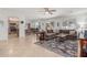 Bright living room featuring neutral walls, tile flooring, and a comfortable brown sectional sofa with stylish rug at 1142 E Mayfield Dr, San Tan Valley, AZ 85143