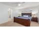 This main bedroom boasts an ensuite bathroom with a large bed and plush blue bedding at 1142 E Mayfield Dr, San Tan Valley, AZ 85143