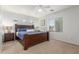 This main bedroom features a spacious layout, ceiling fan, and a large window for natural light at 1142 E Mayfield Dr, San Tan Valley, AZ 85143